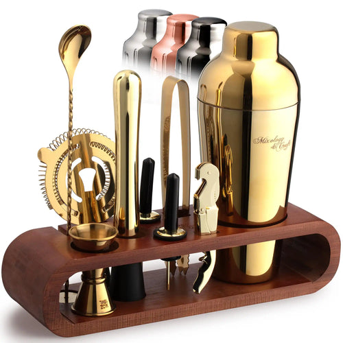 Set of gold and silver cocktail shakers and tools on a wooden stand with a white background.